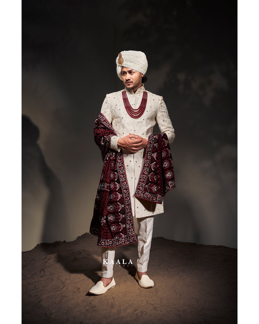 Off white with maroon combination of embroidery shervani for groom.